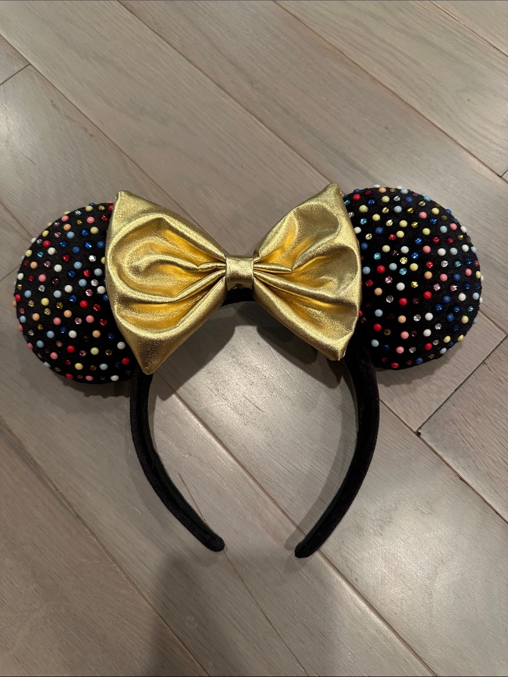 BaubleBar Black Ear Headband with Gold Bow and Multicolor Studs